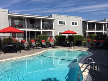 Pool with Furniture and apts buildng Apartments in Oceanside, CA l The Pointe at 2316